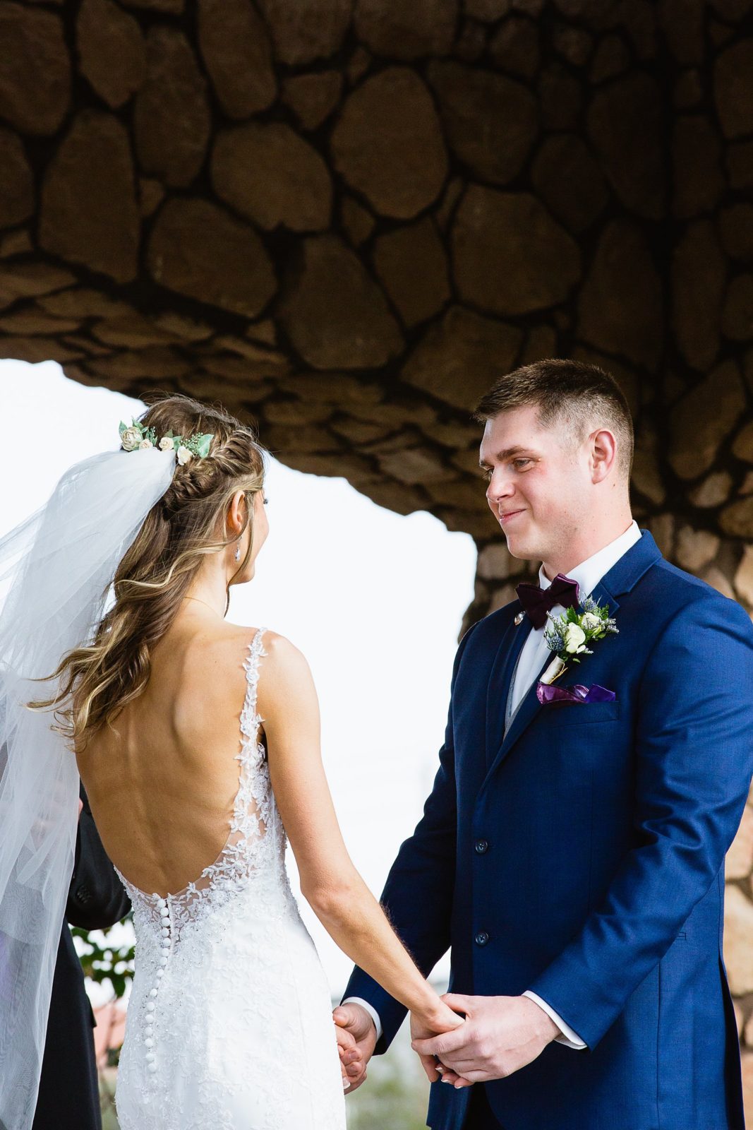 Groom looking at his bride during their wedding ceremony at Superstition Manor by Mesa wedding photographer PMA Photography.