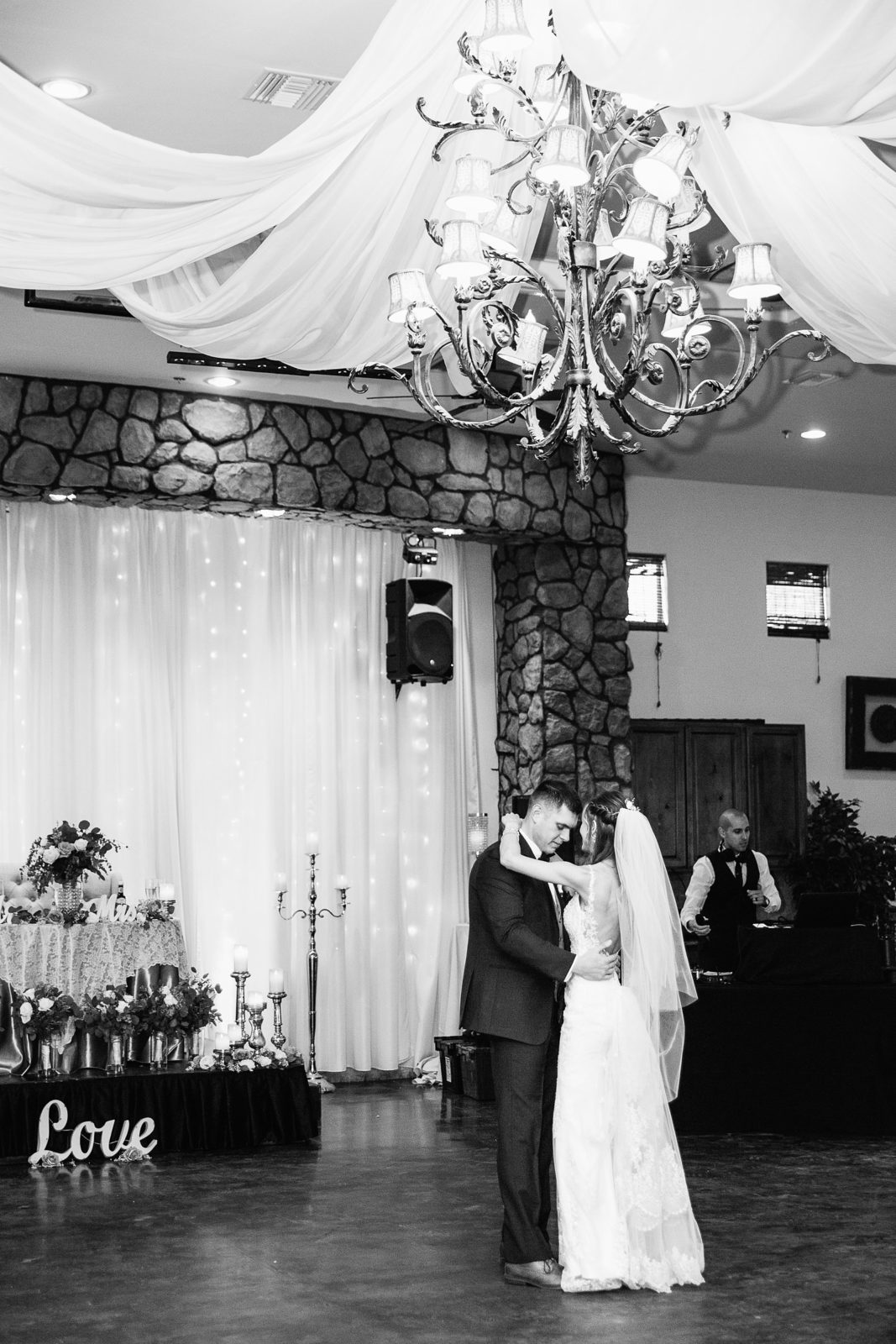 Bride and Groom sharing first dance at their Superstition Manor wedding reception by Arizona wedding photographer PMA Photography.