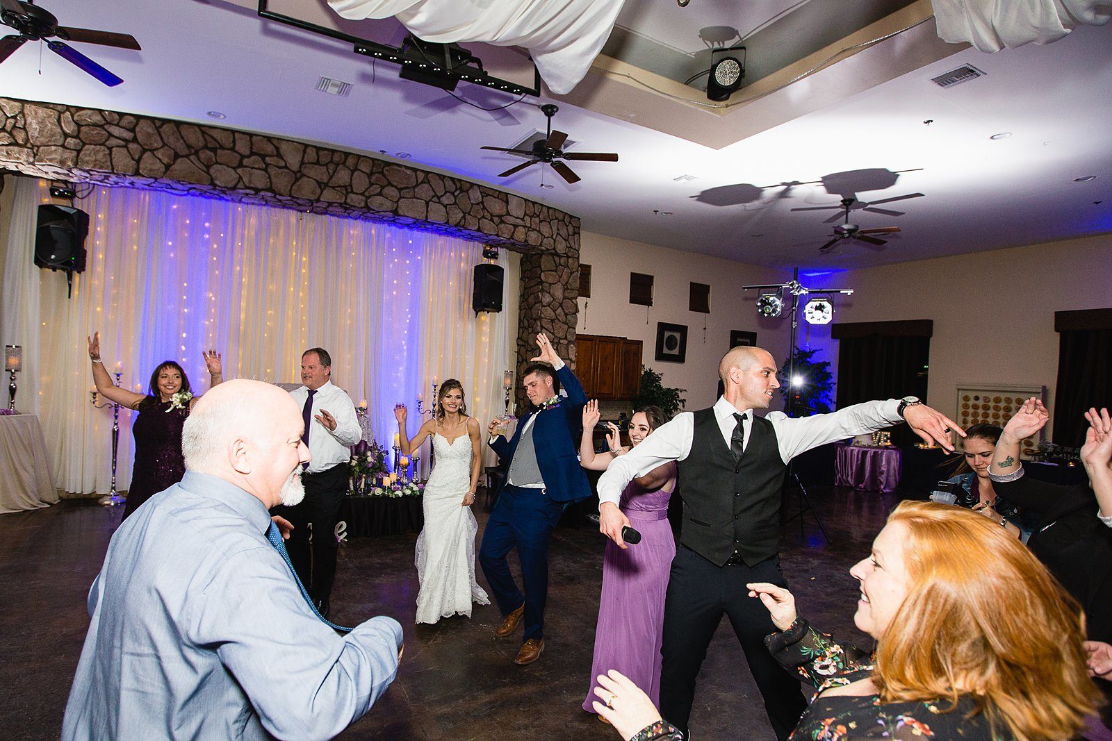 Bride and Groom dancing with guests at their Superstition Manor wedding reception by Arizona wedding photographer PMA Photography