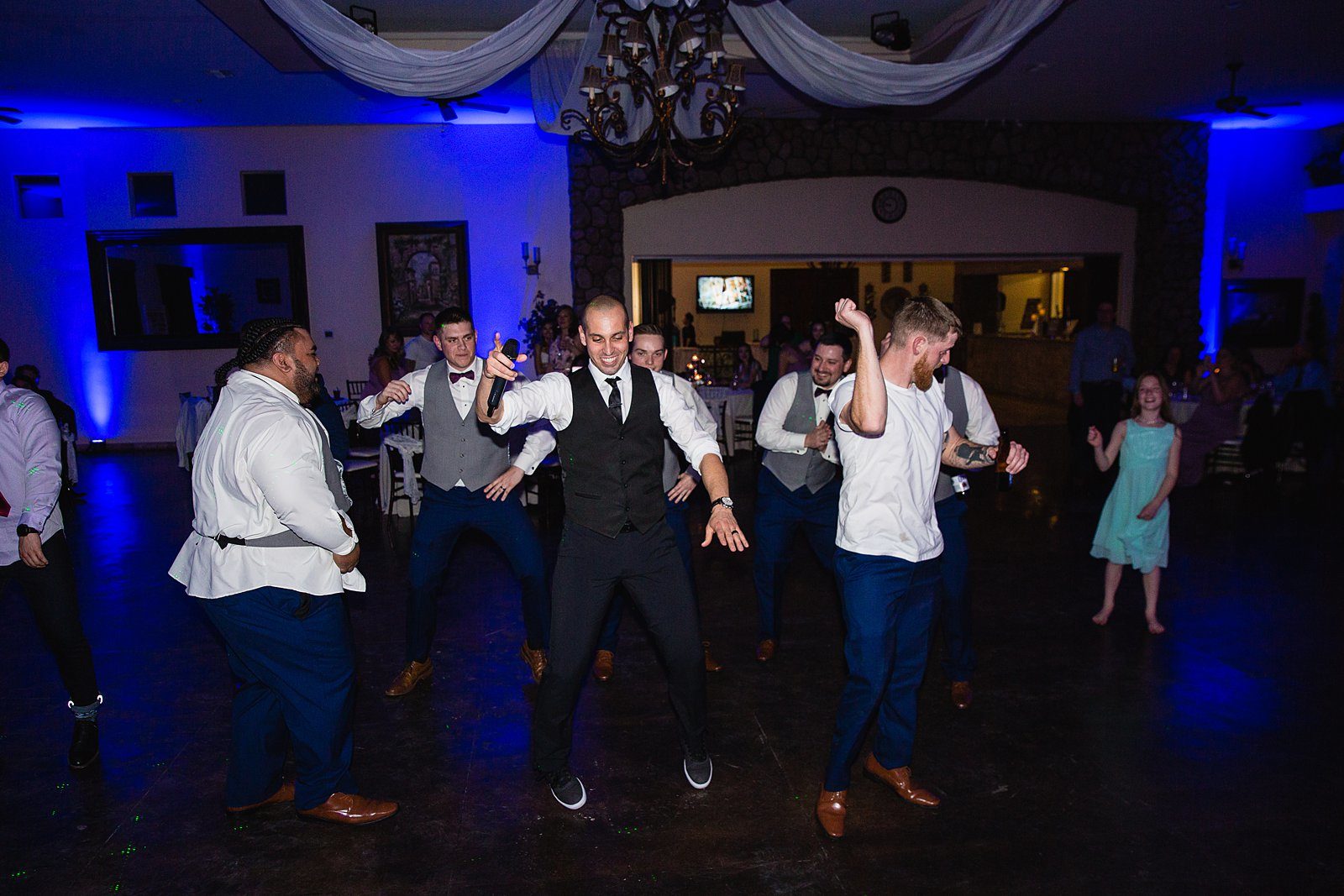 Groom dancing with guests at his Superstition Manor wedding reception by Arizona wedding photographer PMA Photography