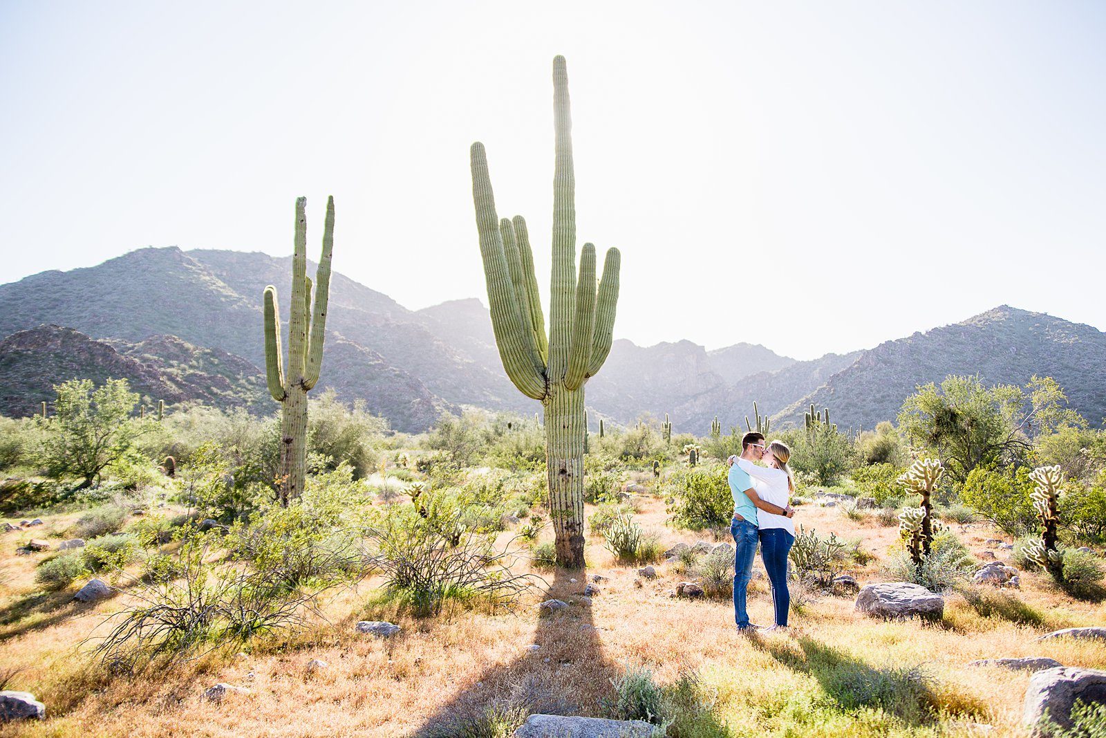 Couple pose for their White Tanks desert engagement session by Wadell wedding photographer PMA Photography.