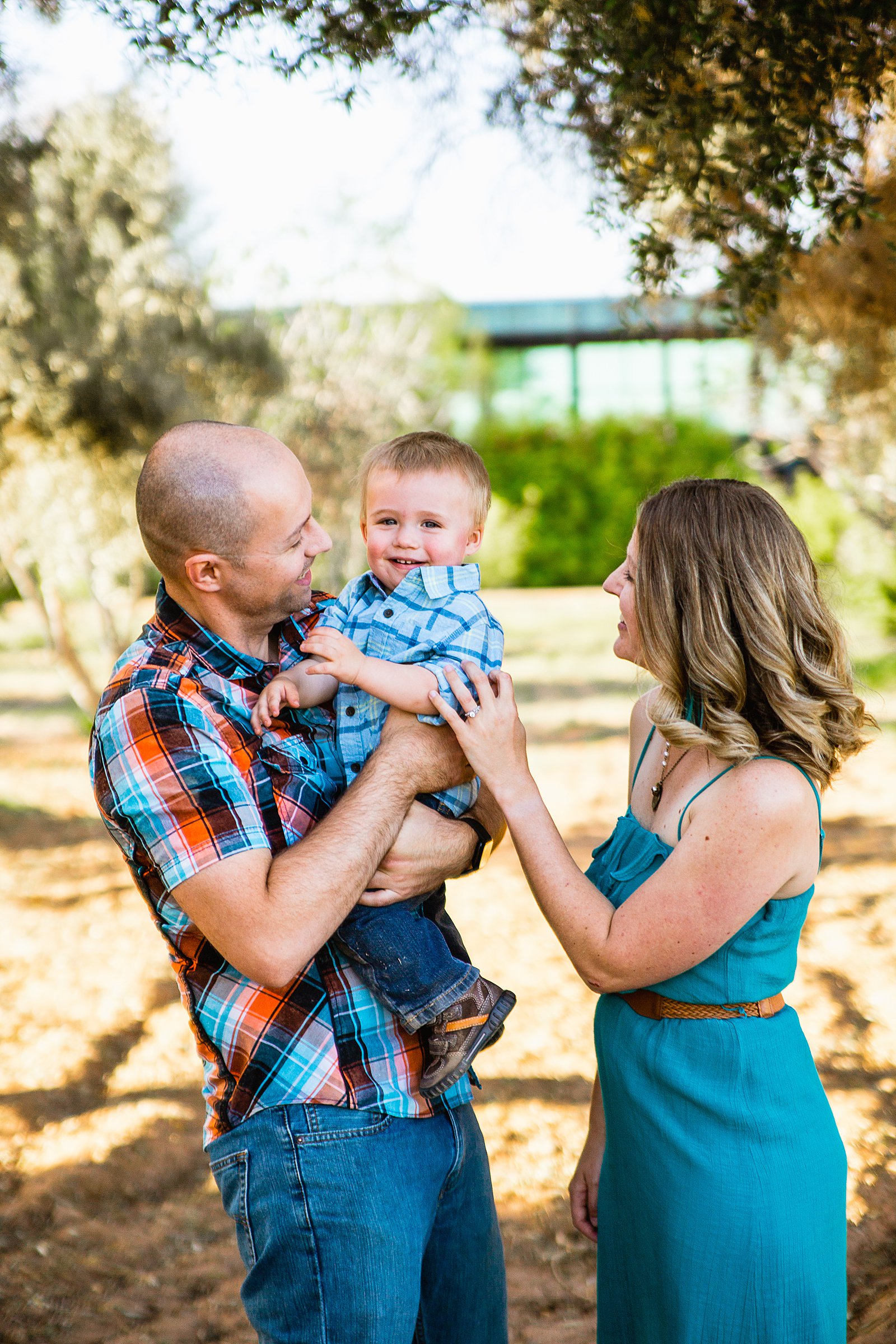 Couple with their son during their Sahuaro Ranch Park engagement session by Phoenix wedding photographer PMA Photography.