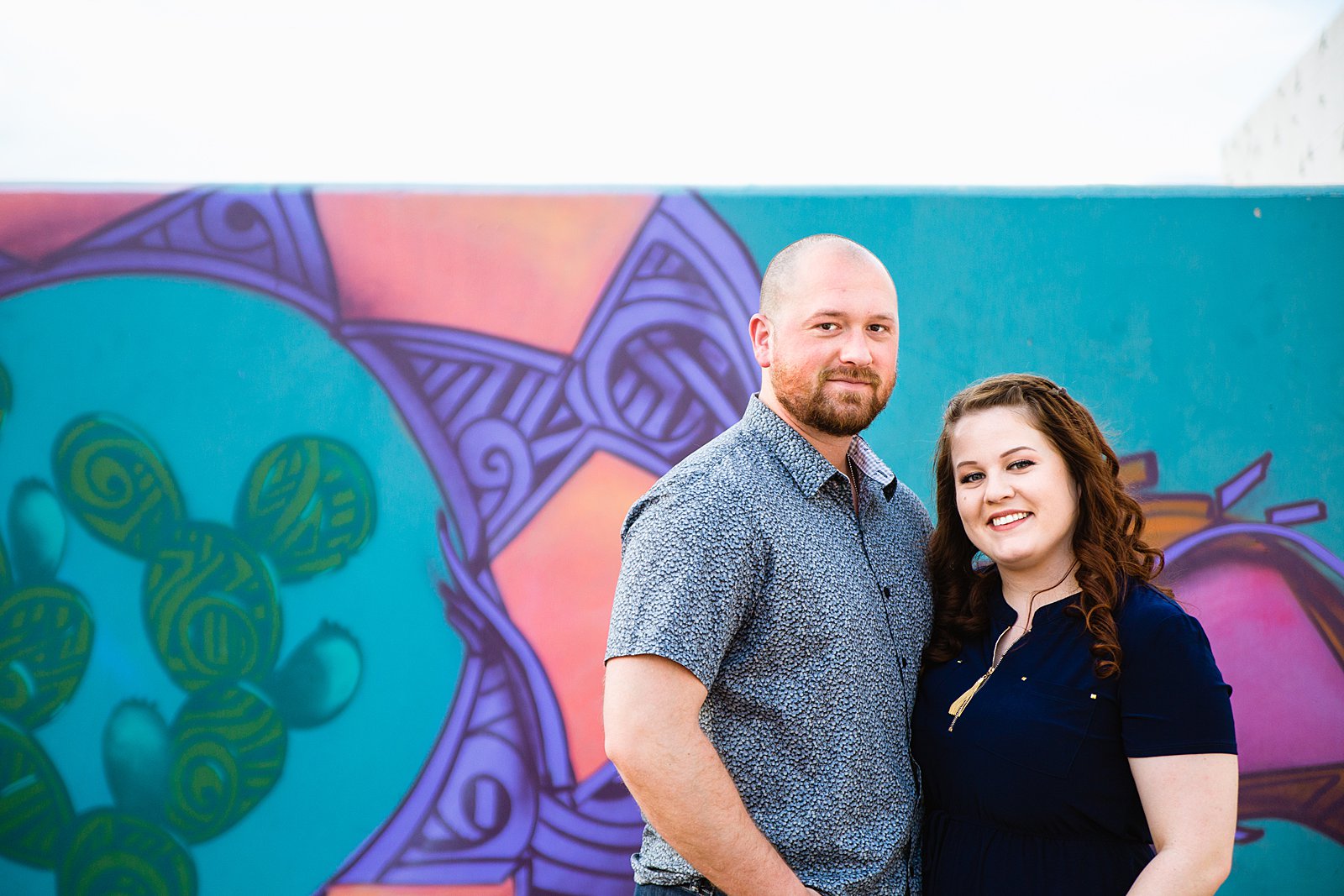 Couple pose for their Roosevelt Row engagement session by Phoenix wedding photographer PMA Photography.