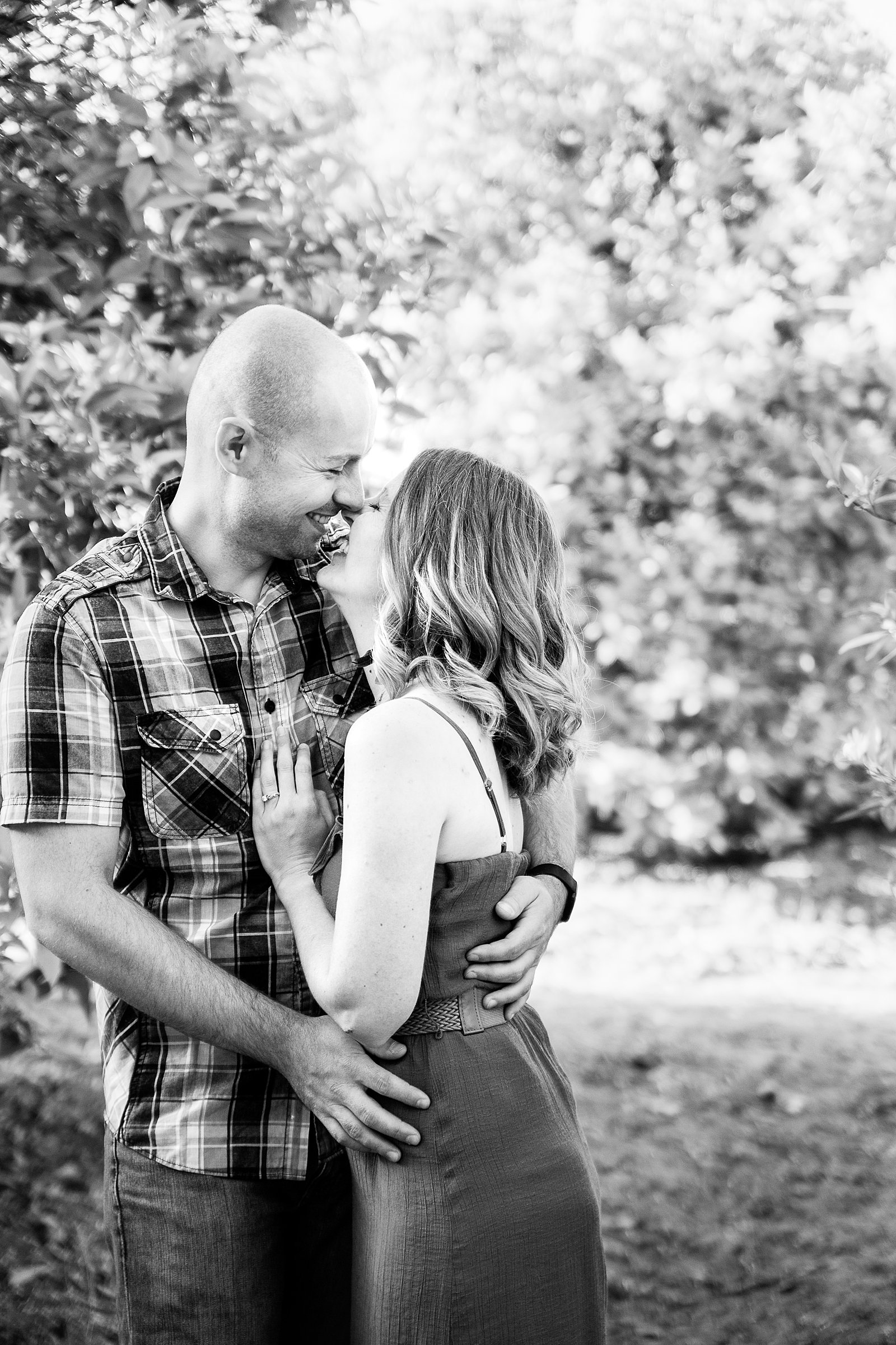 Couple share an intimate moment during their Sahuaro Ranch engagement session by Phoenix engagement photographer PMA Photography.