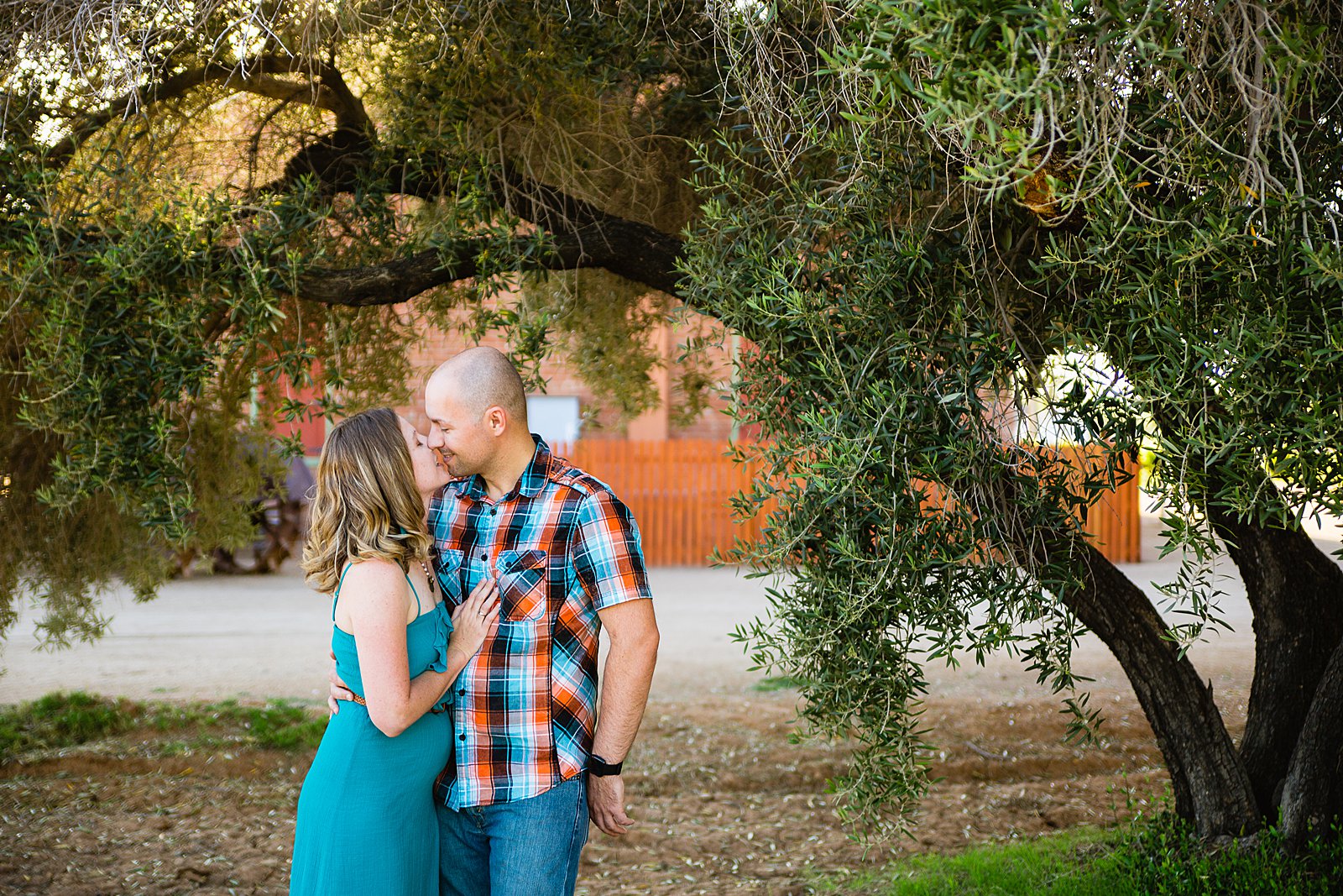 Couple share an intimate moment during their Sahuaro Ranch engagement session by Phoenix engagement photographer PMA Photography.