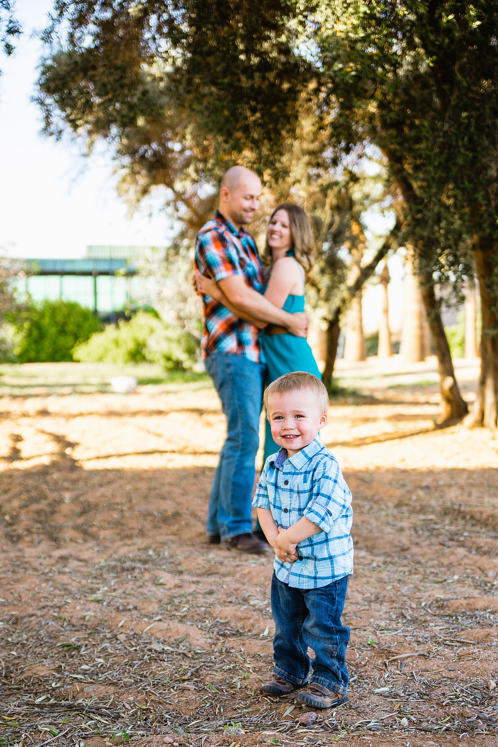 Couple with their son during their Sahuaro Ranch Park engagement session by Phoenix wedding photographer PMA Photography.