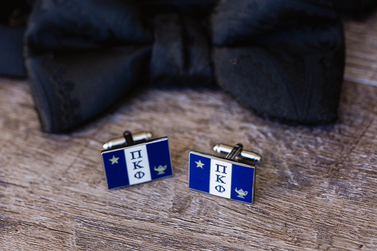 Groom's wedding day details of cuff links from his fraternity by PMA Photography.