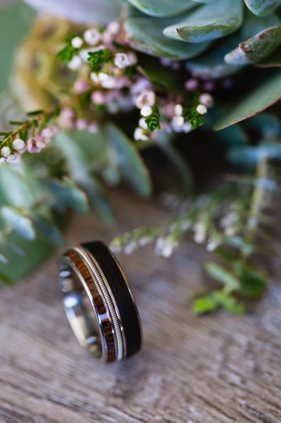 Groom's unique wedding band made of a record, whisky barrel, and guitar string by PMA Photography.