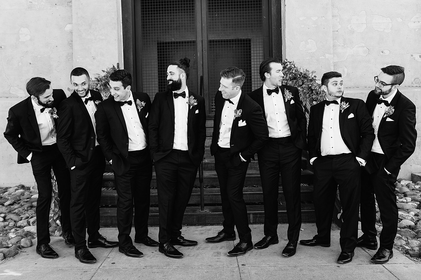 Groom and groomsmen laughing together at The Ice House wedding by Phoenix wedding photographer PMA Photography.