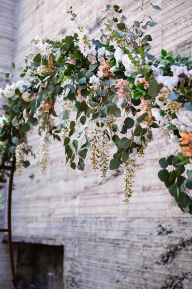 Romantic, bohemian floral wedding arch at the Ice House wedding venue by Phoenix wedding photographer PMA Photography.