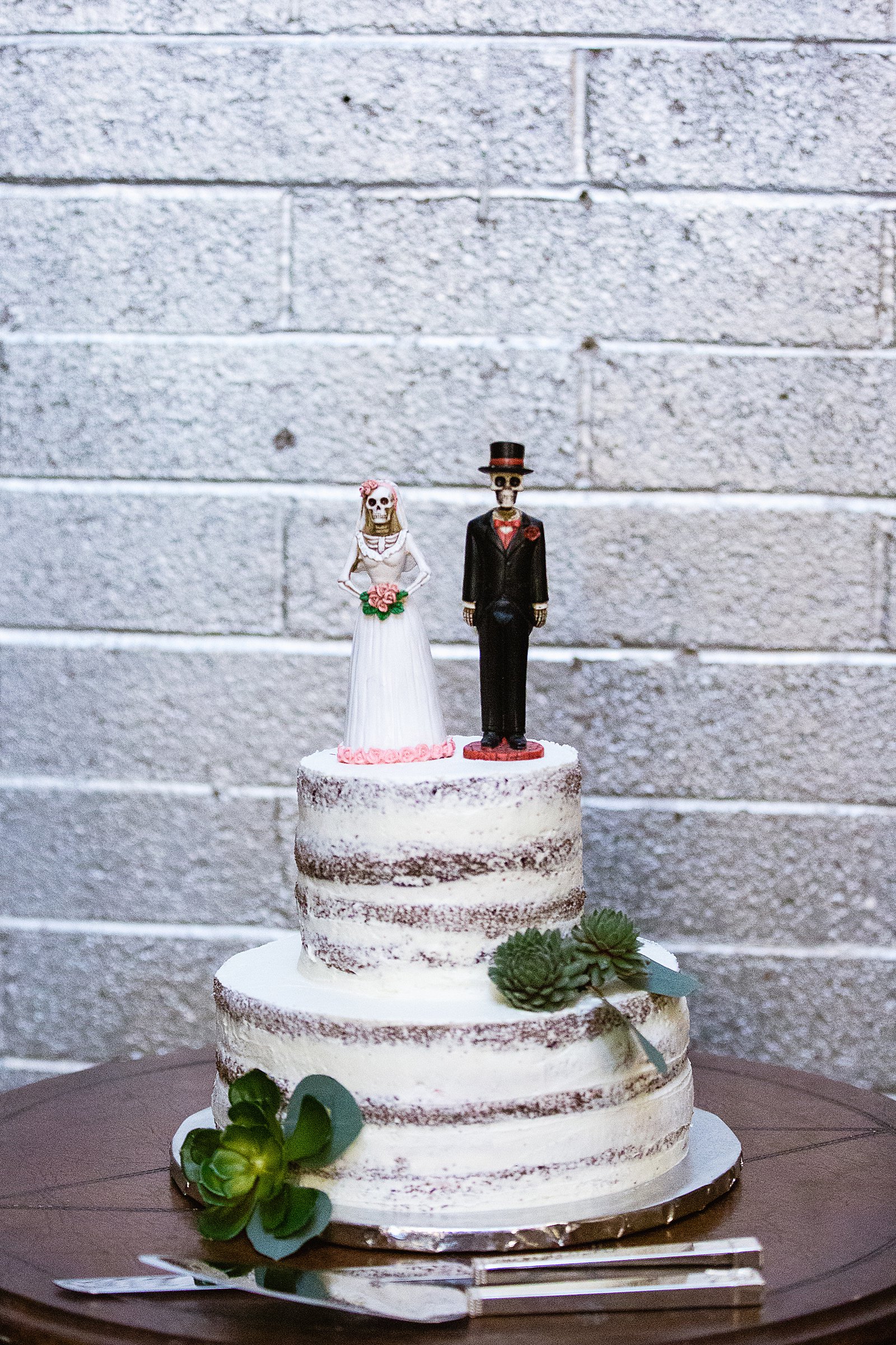 Unique, alternative wedding cake topper of a skeleton bride and groom by Arizona wedding photographer PMA Photography.