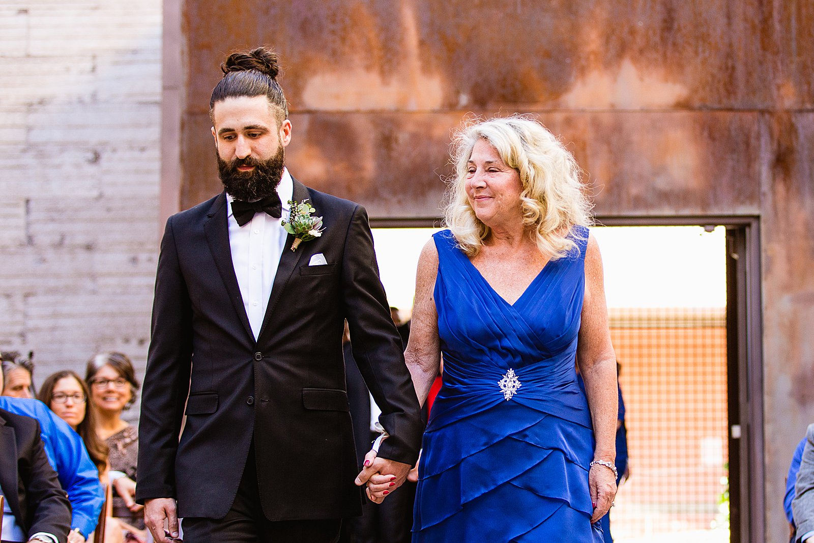 Groom walking down the aisle with his mother by Arizona wedding photographer PMA Photography.
