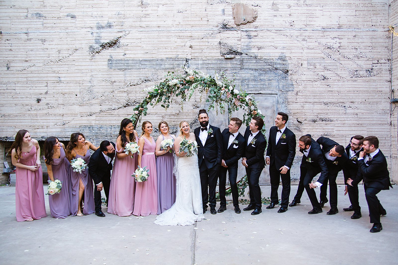 Bridal party having fun together at The Ice House weding by Arizona wedding photographer PMA Photography.