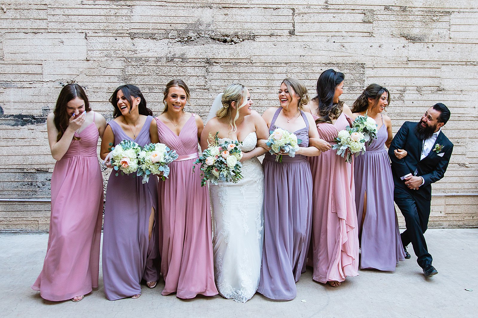 Bride and bridesmaids laughing together at The Ice House wedding by Phoenix wedding photographer PMA Photography.
