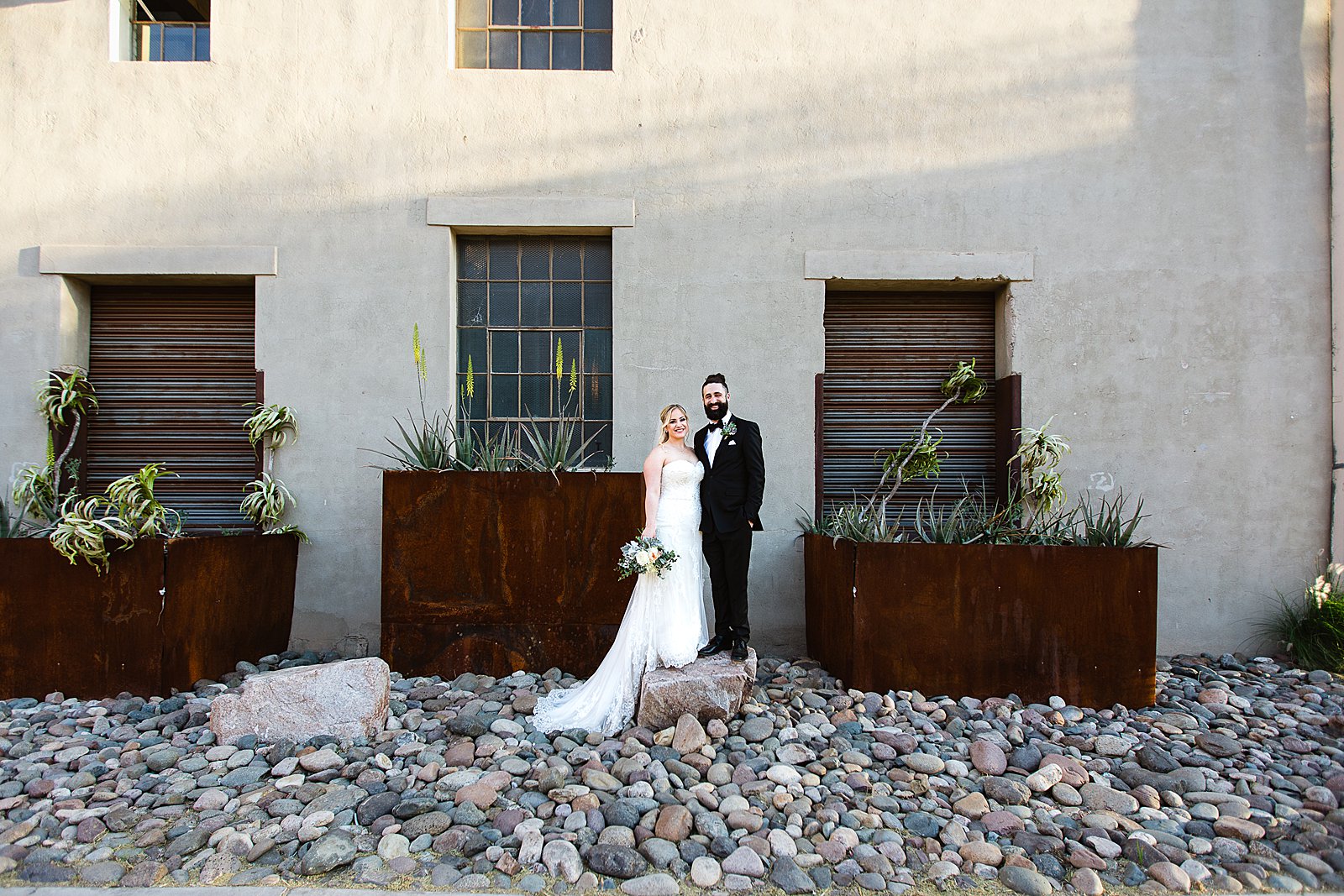 Bride and Groom pose for their The Ice House wedding by Phoenix wedding photographer PMA Photography.