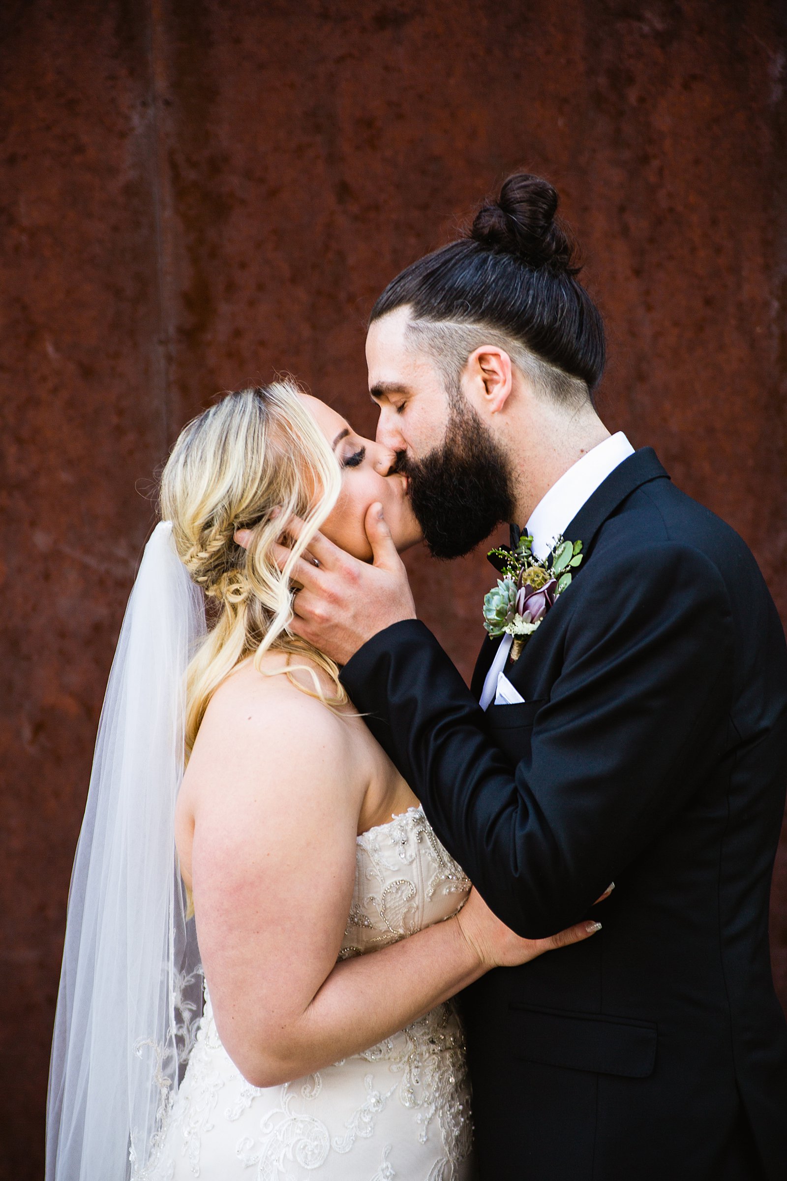 Bride and Groom share a kiss during their The Ice House wedding by Phoenix wedding photographer PMA Photography.