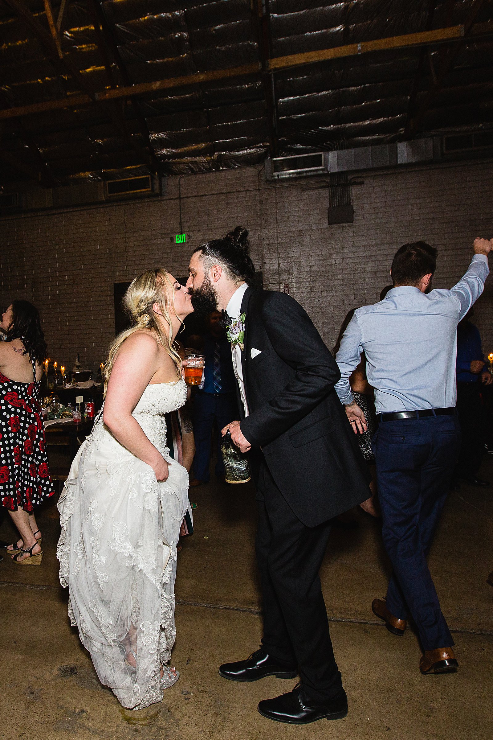 Bride and Groom dancing with guests at their The Ice House wedding reception by Arizona wedding photographer PMA Photography