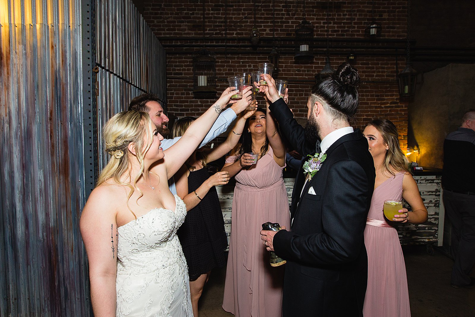 Bride and groom share shots with guests at their first Ice House wedding reception by Arizona wedding photographer PMA photography.