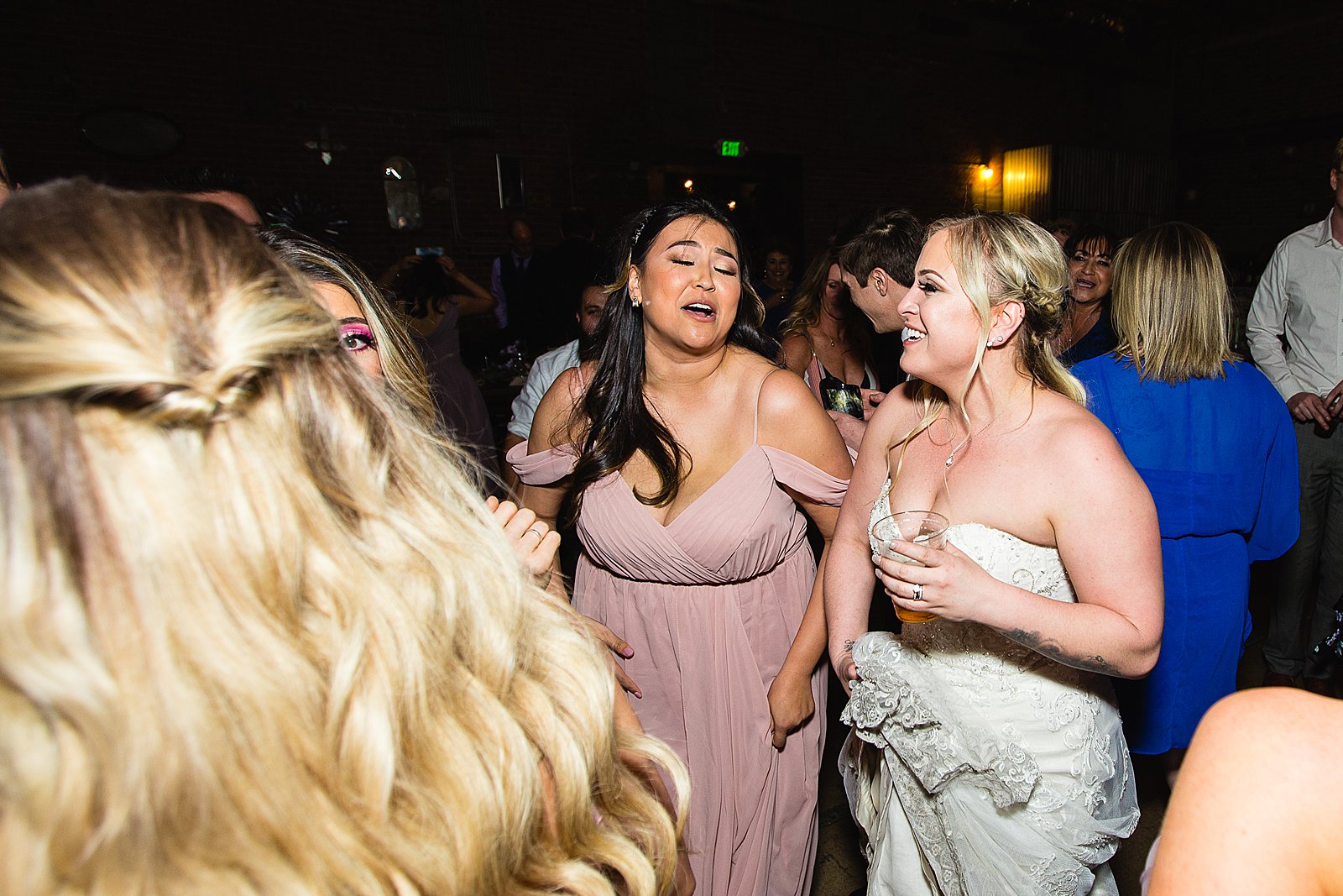 Bride dancing with guests at The Ice House wedding reception by Phoenix wedding photographer PMA Photography
