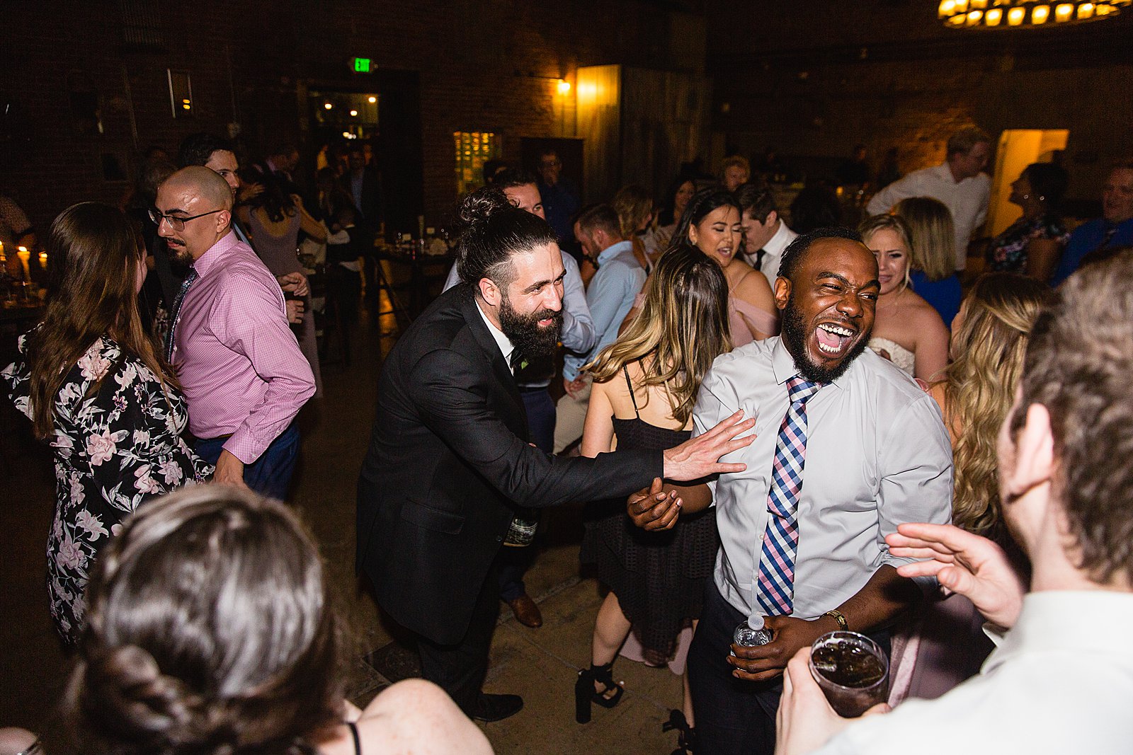 Groom dancing with guests at The Ice House wedding reception by Phoenix wedding photographer PMA Photography
