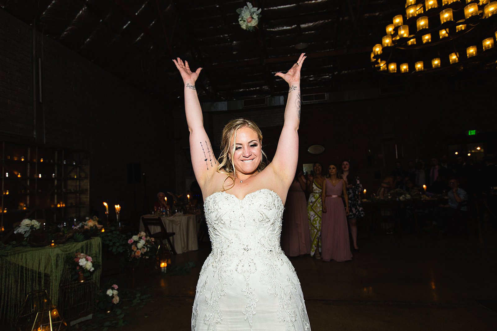 Bouquet toss at The Ice House wedding reception by Phoenix wedding photographer PMA Photography.