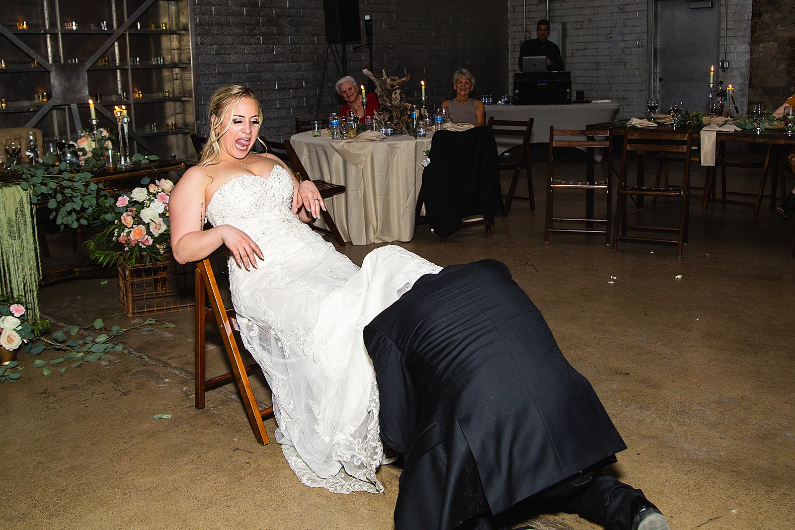 Garter toss at The Ice House wedding reception by Phoenix wedding photographer PMA Photography.