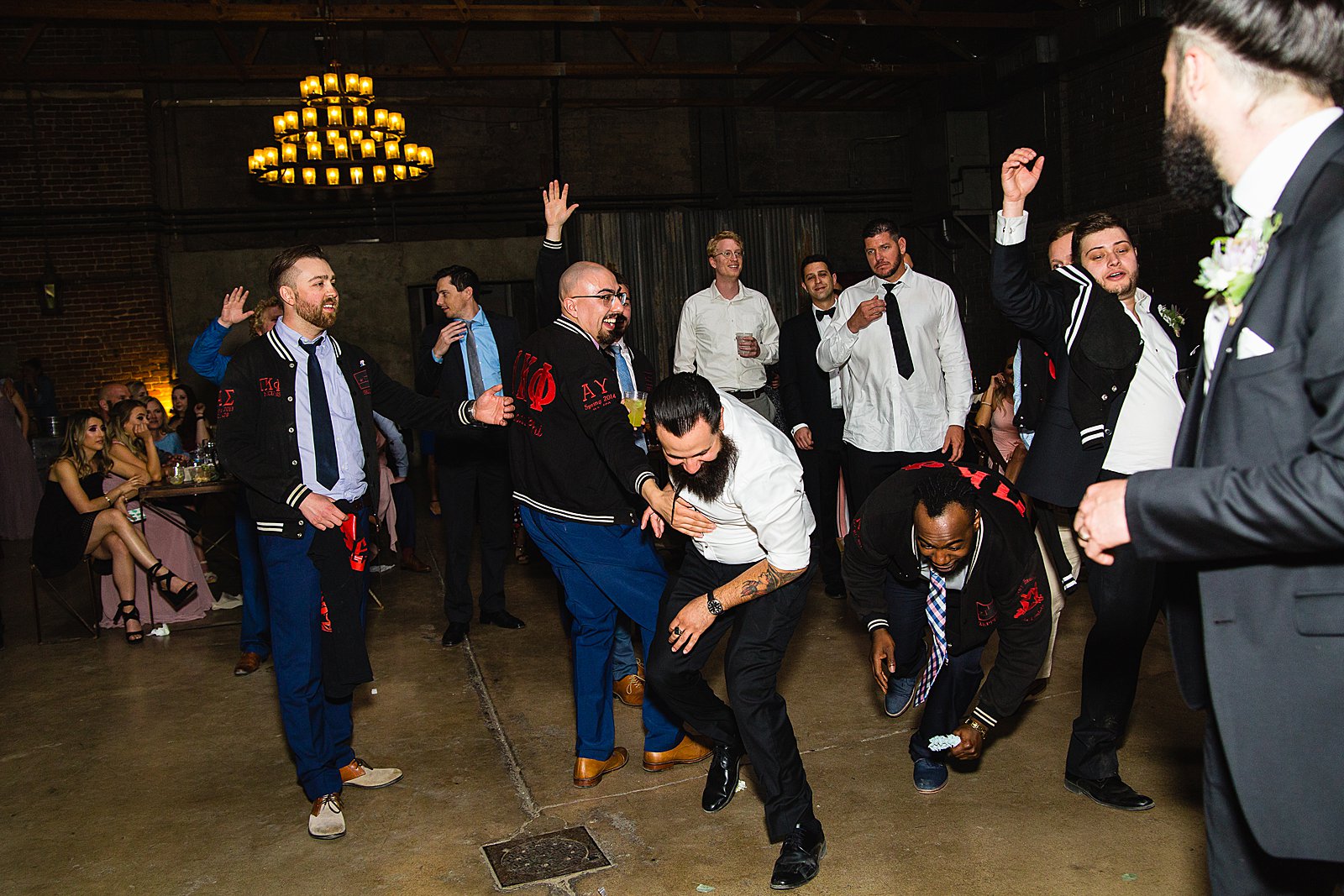 Garter toss at The Ice House wedding reception by Phoenix wedding photographer PMA Photography.