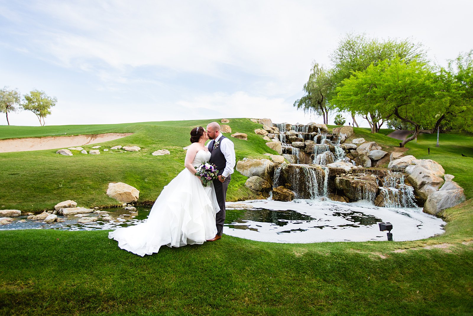 Bride and Groom share a kiss during their Arizona Grand Resort wedding by Phoenix wedding photographer PMA Photography.
