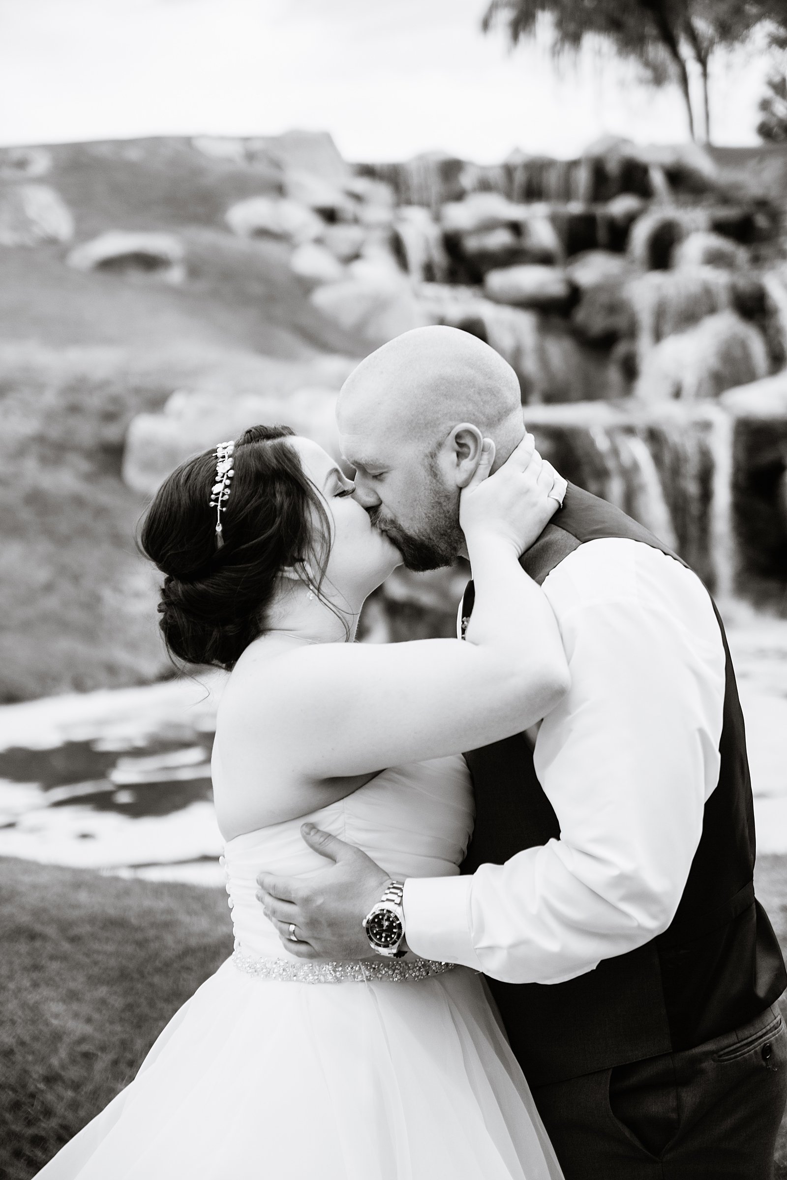 Bride and Groom share a kiss during their Arizona Grand Resort wedding by Arizona wedding photographer PMA Photography.