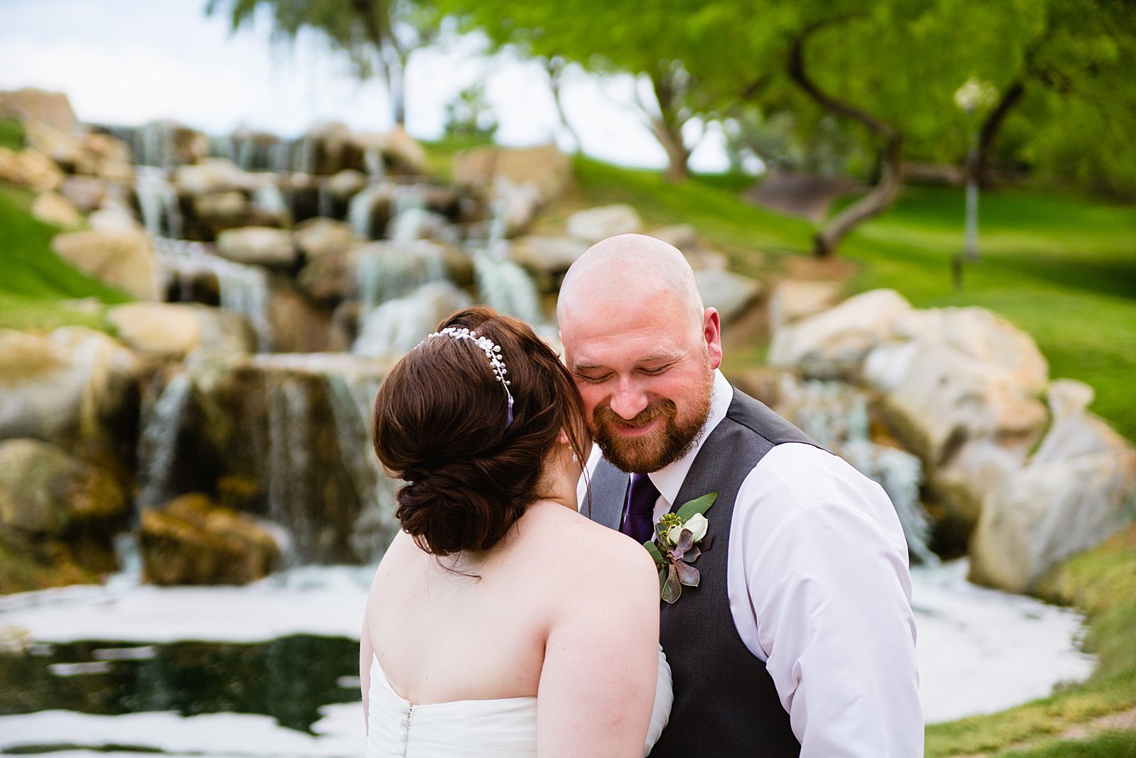 Bride and Groom laughing together during their Arizona Grand Resort wedding by Arizona wedding photographer PMA Photography.