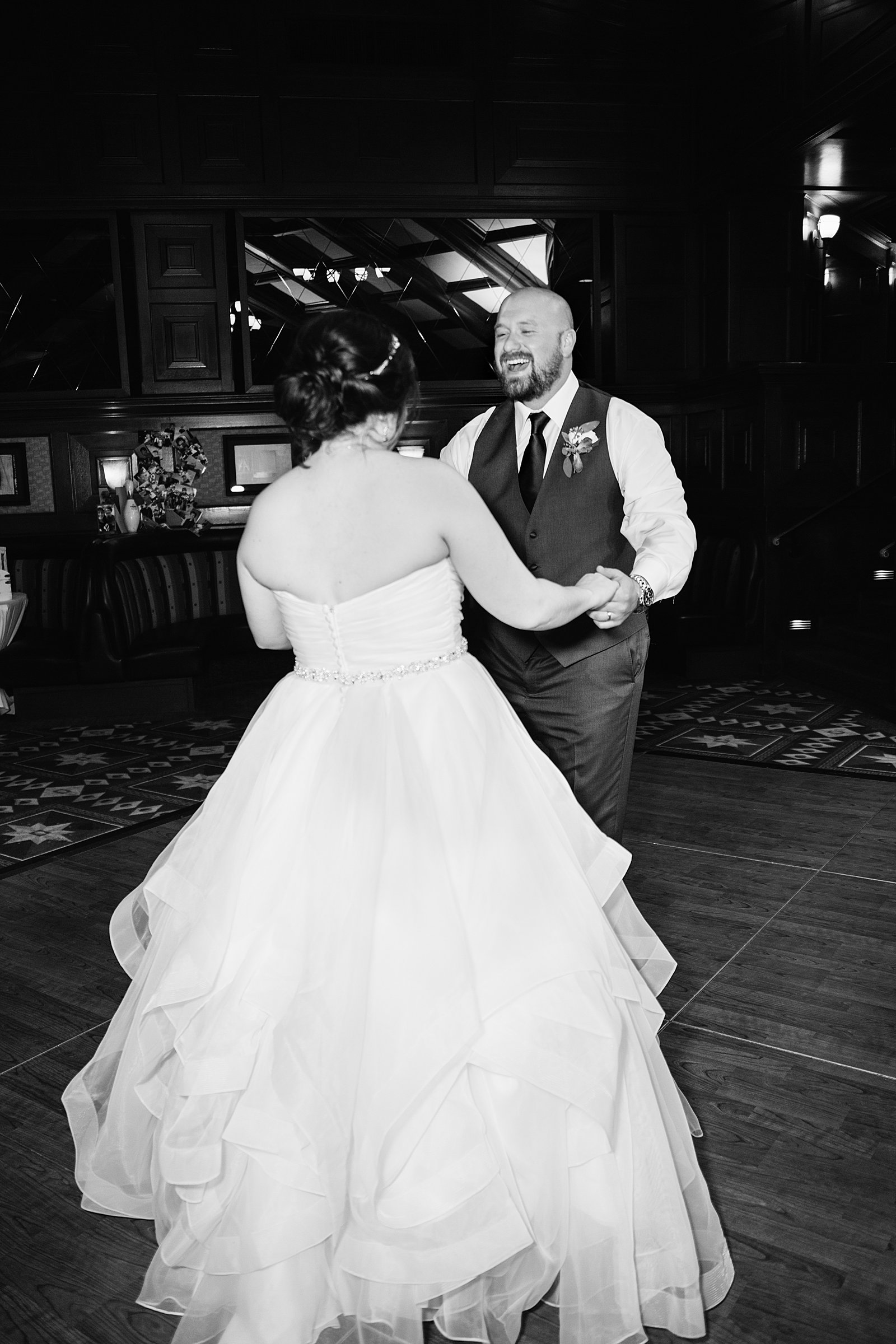 Bride and Groom sharing first dance at their Arizona Grand Resort wedding reception by Arizona wedding photographer PMA Photography.