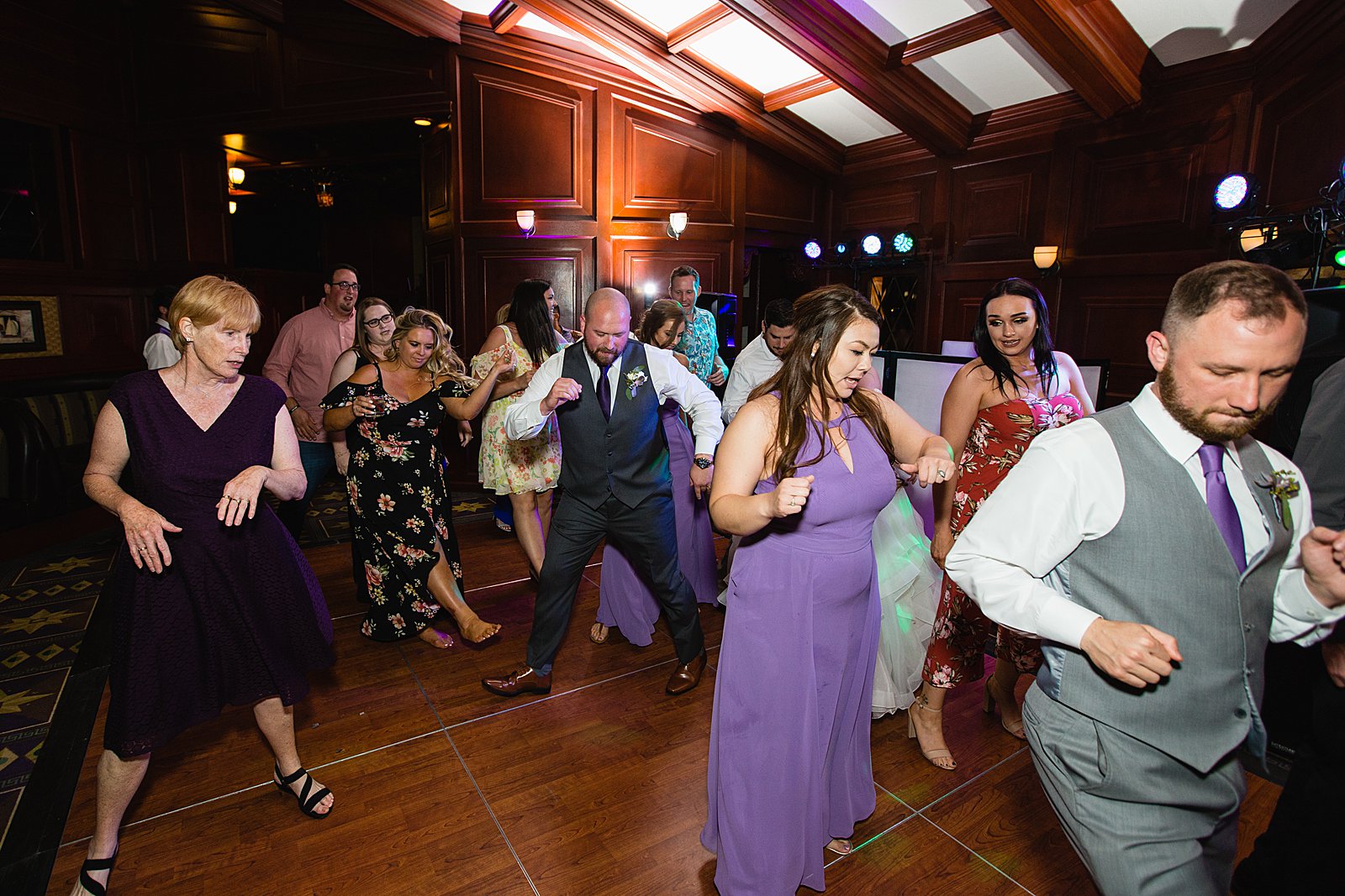 Bride and Groom dancing with guests at their Arizona Grand Resort wedding reception by Arizona wedding photographer PMA Photography