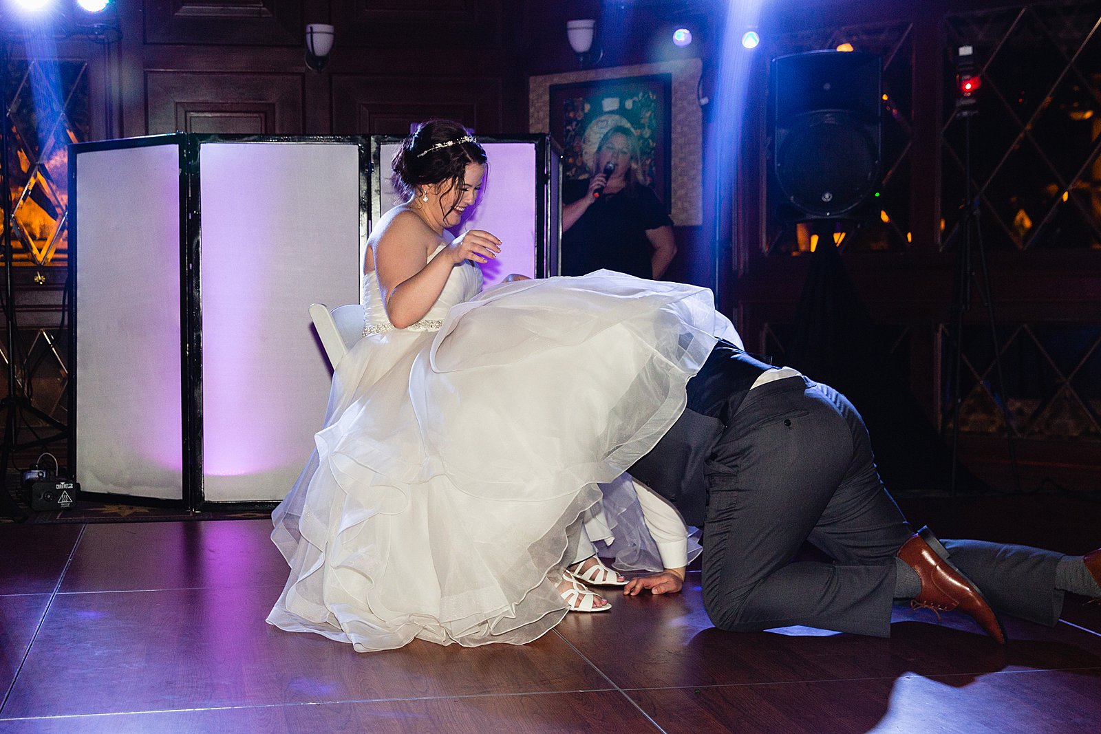 Garter toss at Arizona Grand Resort wedding reception by Phoenix wedding photographer PMA Photography.