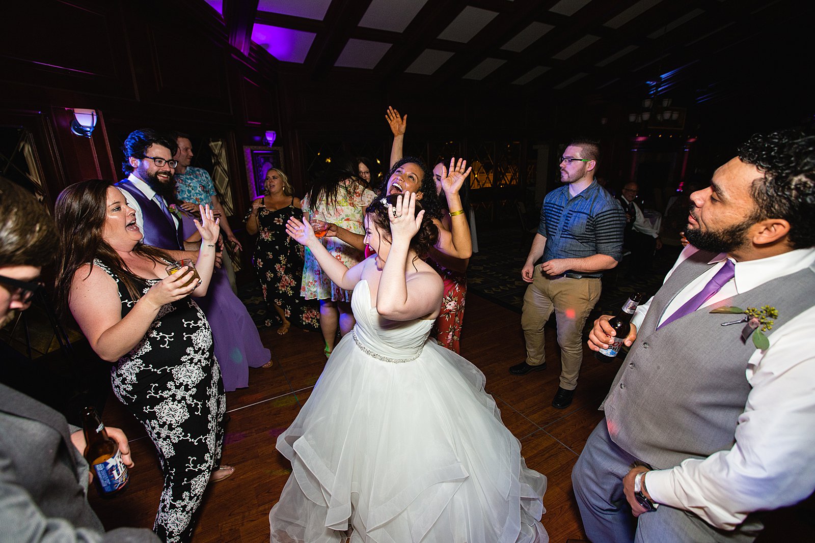 Bride dancing with guests at Arizona Grand Resort wedding reception by Phoenix wedding photographer PMA Photography