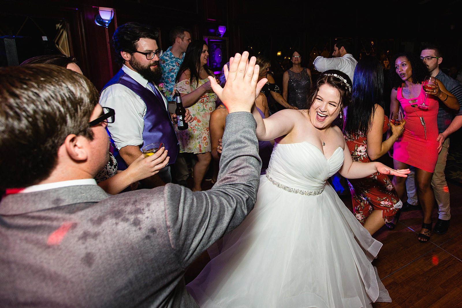 Bride dancing with guests at Arizona Grand Resort wedding reception by Phoenix wedding photographer PMA Photography