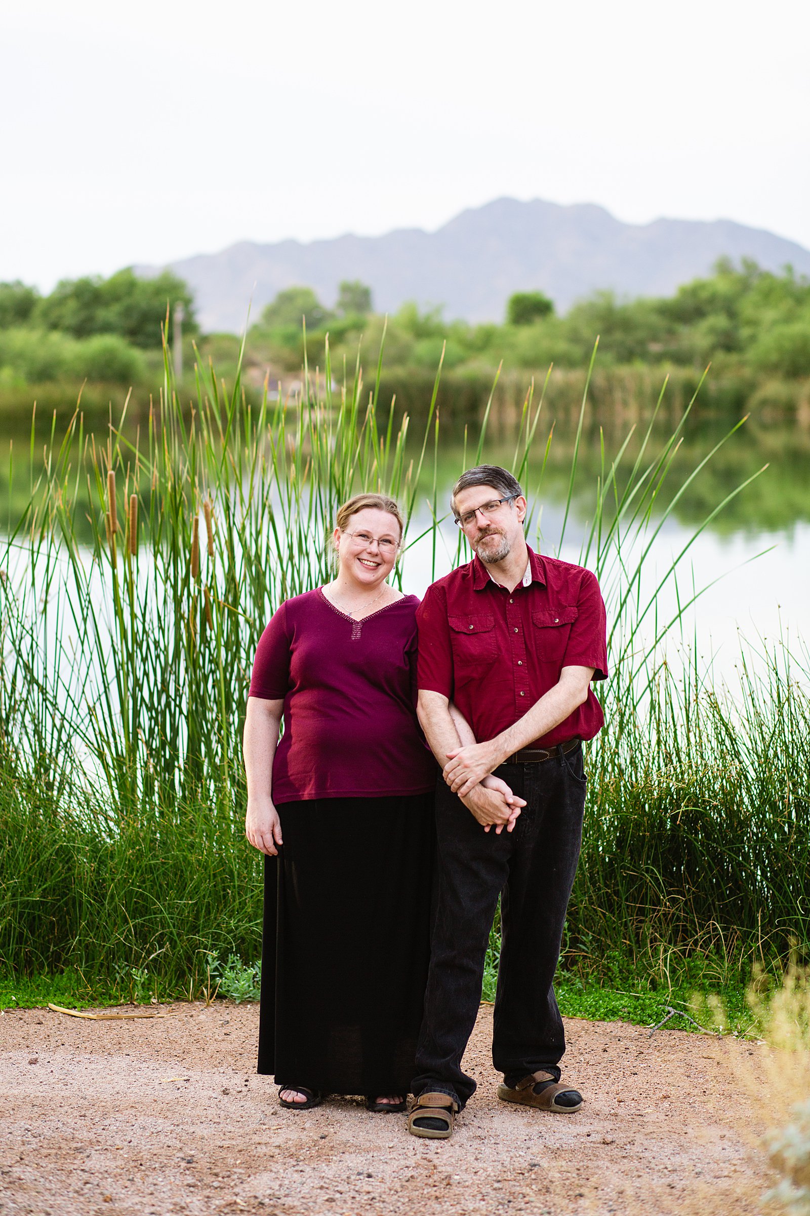 Couple pose during their Gilbert engagement session by Arizona wedding photographer PMA Photography.