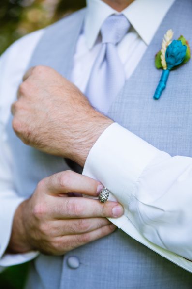 Groom's hops cuff link while getting ready for his wedding by Arizona wedding photographers PMA Photography.