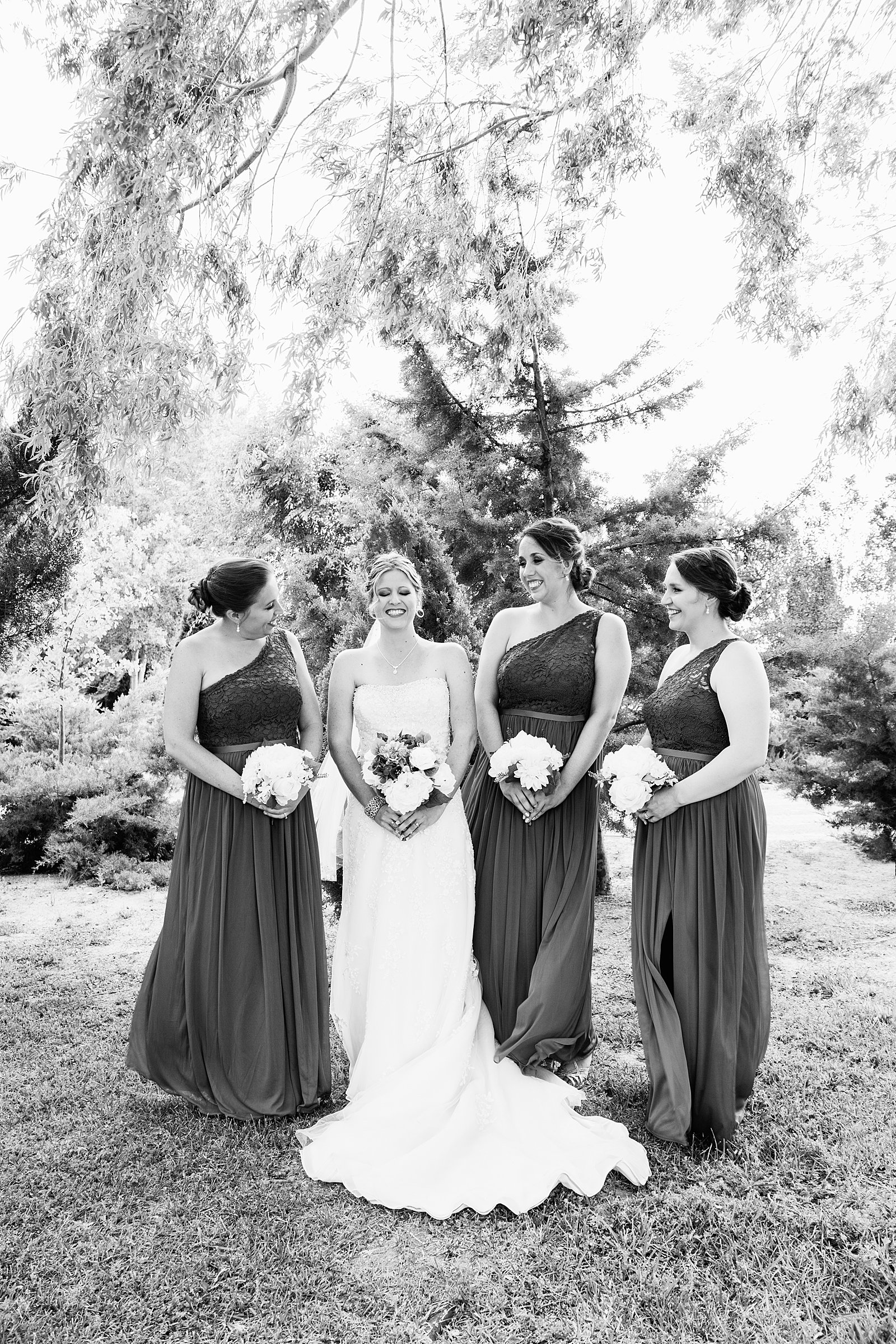 Bride and bridesmaids laughing together at The Windmill House wedding by Chino Valley wedding photographer PMA Photography.