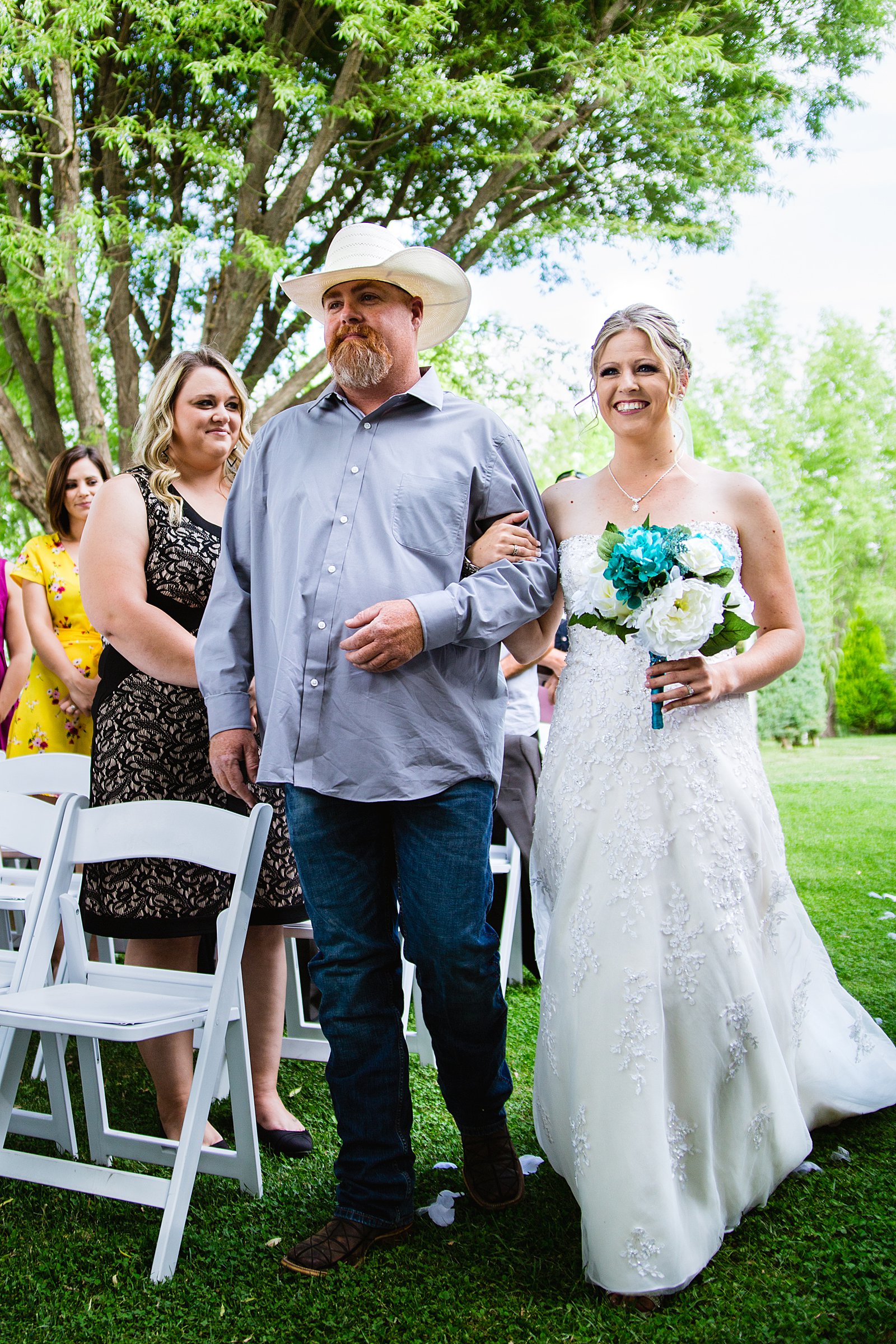 Bride walking down aisle during The Windmill House wedding ceremony by Arizona wedding photographer PMA Photography.