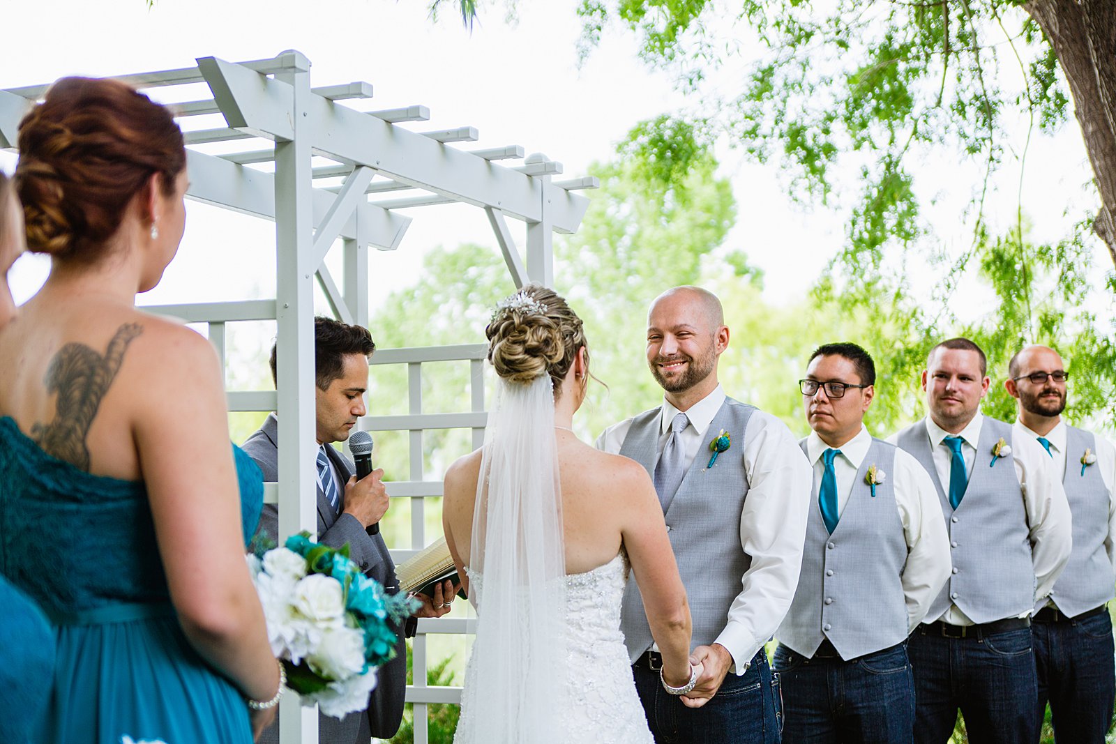 Groom looking at his bride during their wedding ceremony at The Windmill House by Chino Valley wedding photographer PMA Photography.