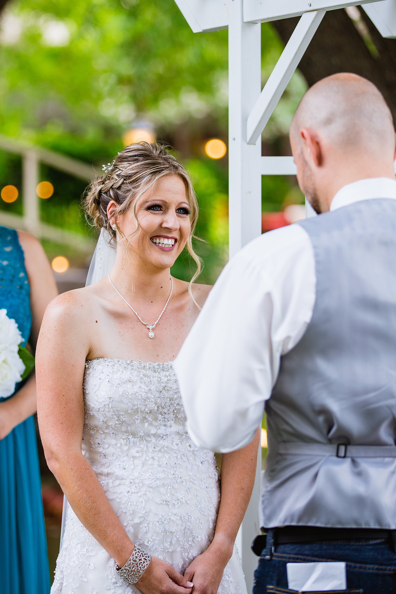 Bride looking at her groom during their wedding ceremony at The Windmill House by Chino Valley wedding photographer PMA Photography.