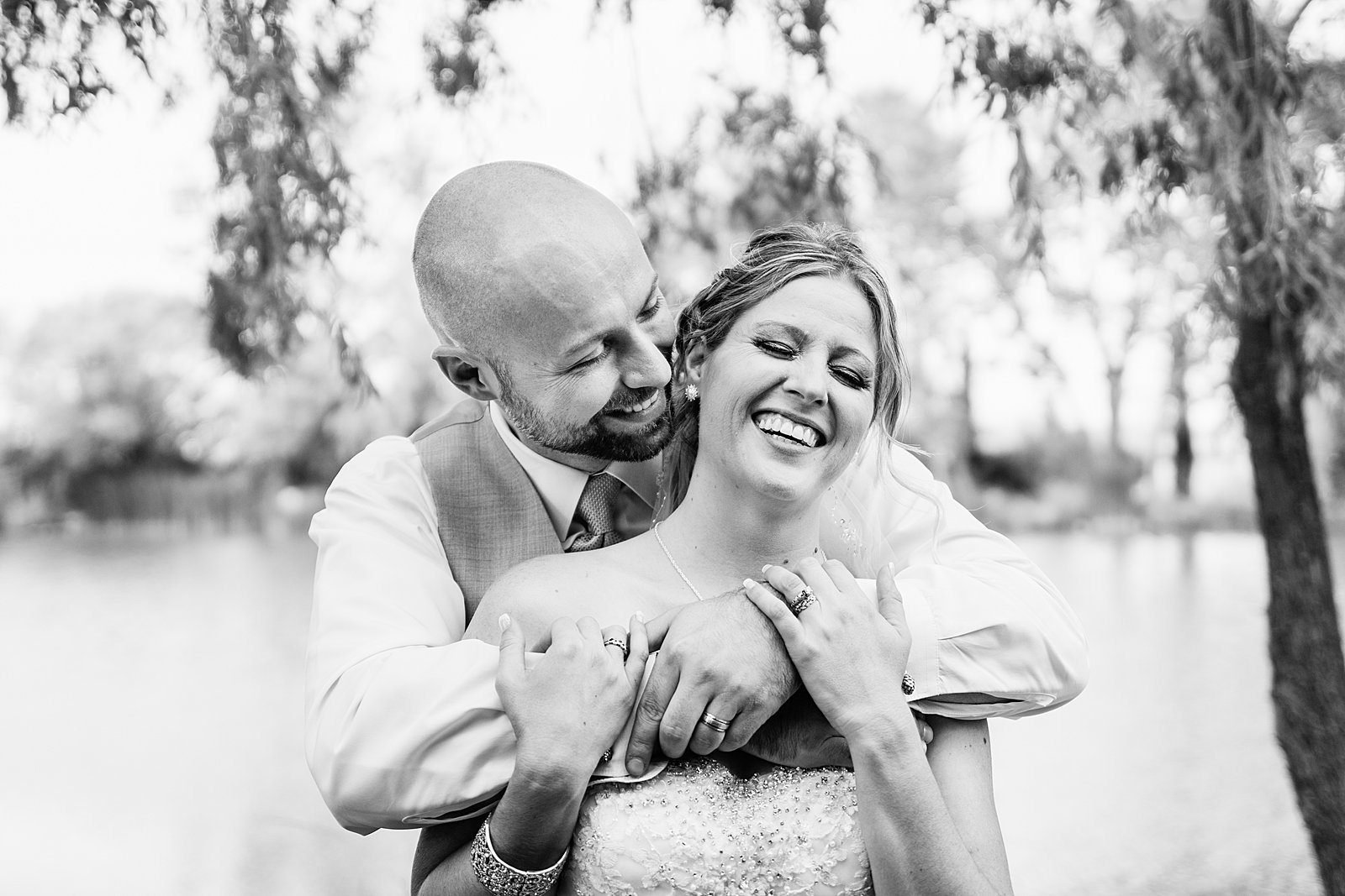 Bride and Groom laughing together during their The Windmill House wedding by Chino Valley wedding photographer PMA Photography.