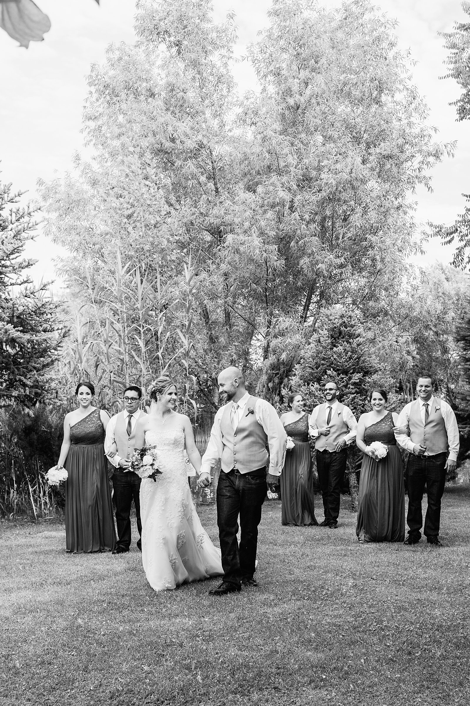 Bridal party walking together at a The Windmill House wedding by Arizona wedding photographer PMA Photography.