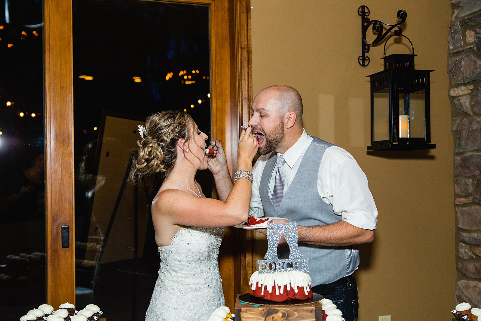 Bride and Groom cutting their wedding cake at their The Windmill House wedding reception by Arizona wedding photographer PMA Photography.