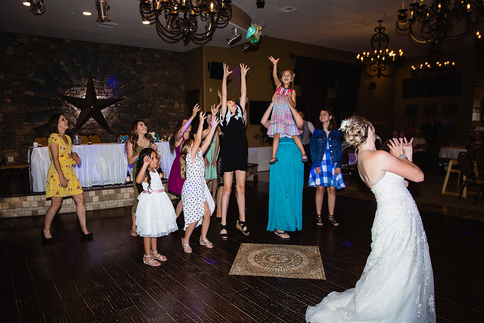 Bouquet toss at The Windmill House wedding reception by Chino Valley wedding photographer PMA Photography.