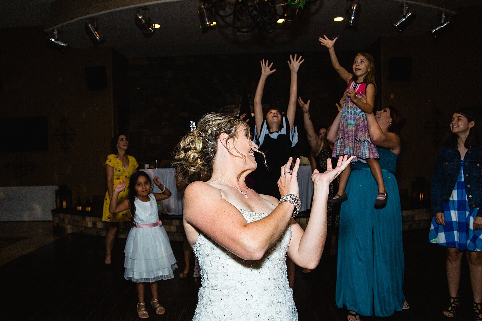 Bouquet toss at The Windmill House wedding reception by Chino Valley wedding photographer PMA Photography.
