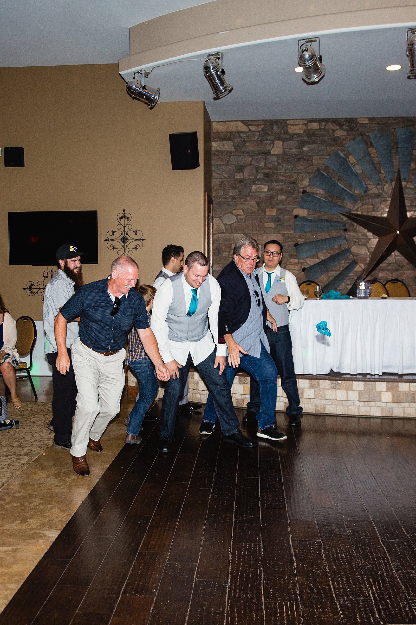 Garter toss at The Windmill House wedding reception by Chino Valley wedding photographer PMA Photography.