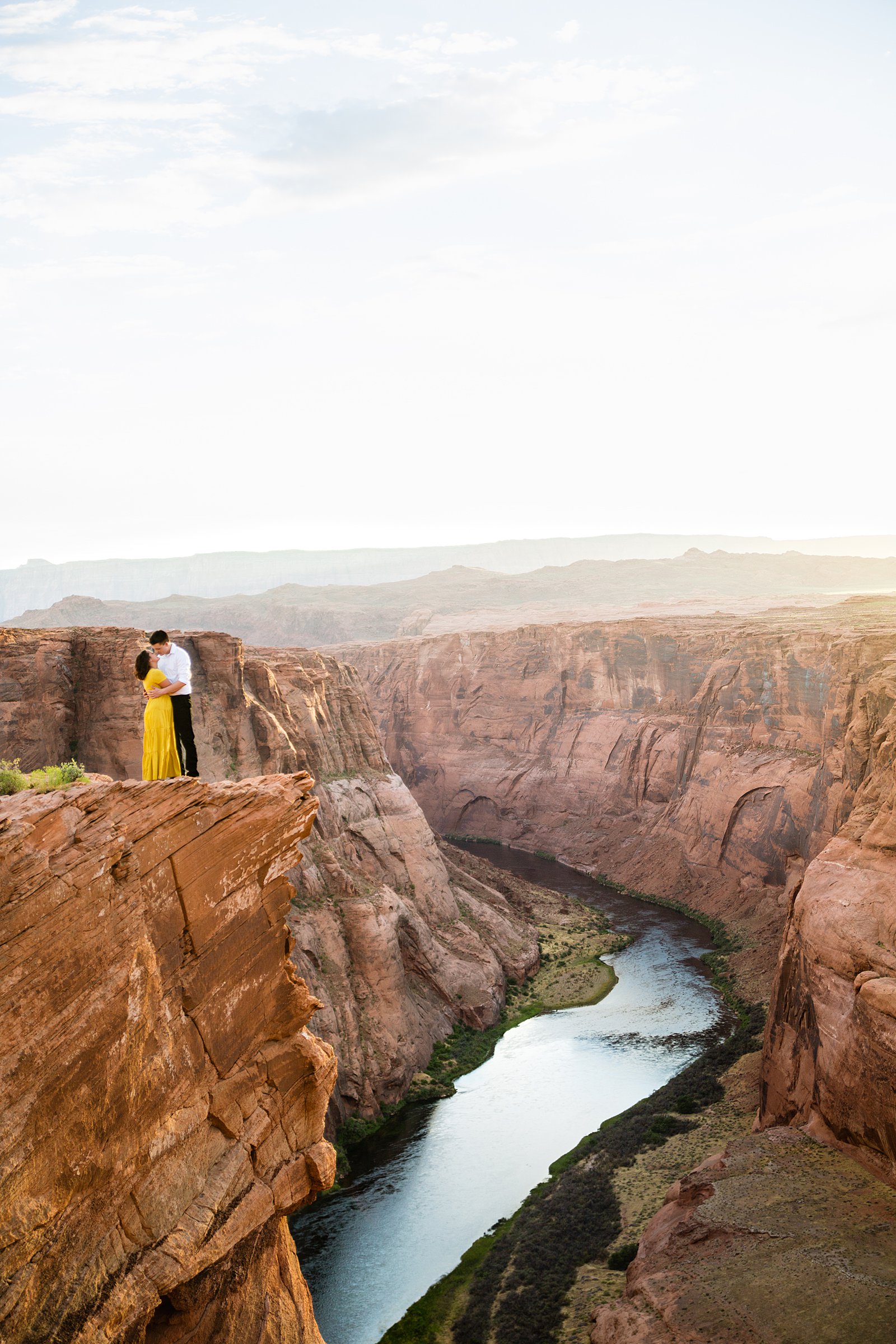 Couple share a kiss during their Horshoe Bend engagement session by Page wedding photographer PMA Photography.