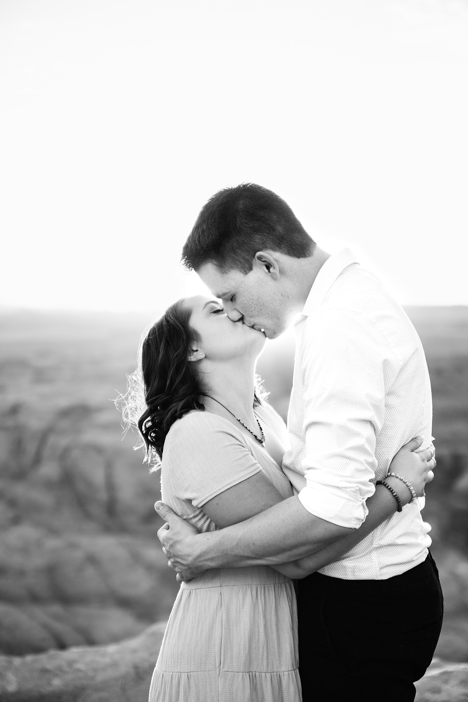 Couple share a kiss during their Horshoe Bend engagement session by Page wedding photographer PMA Photography.