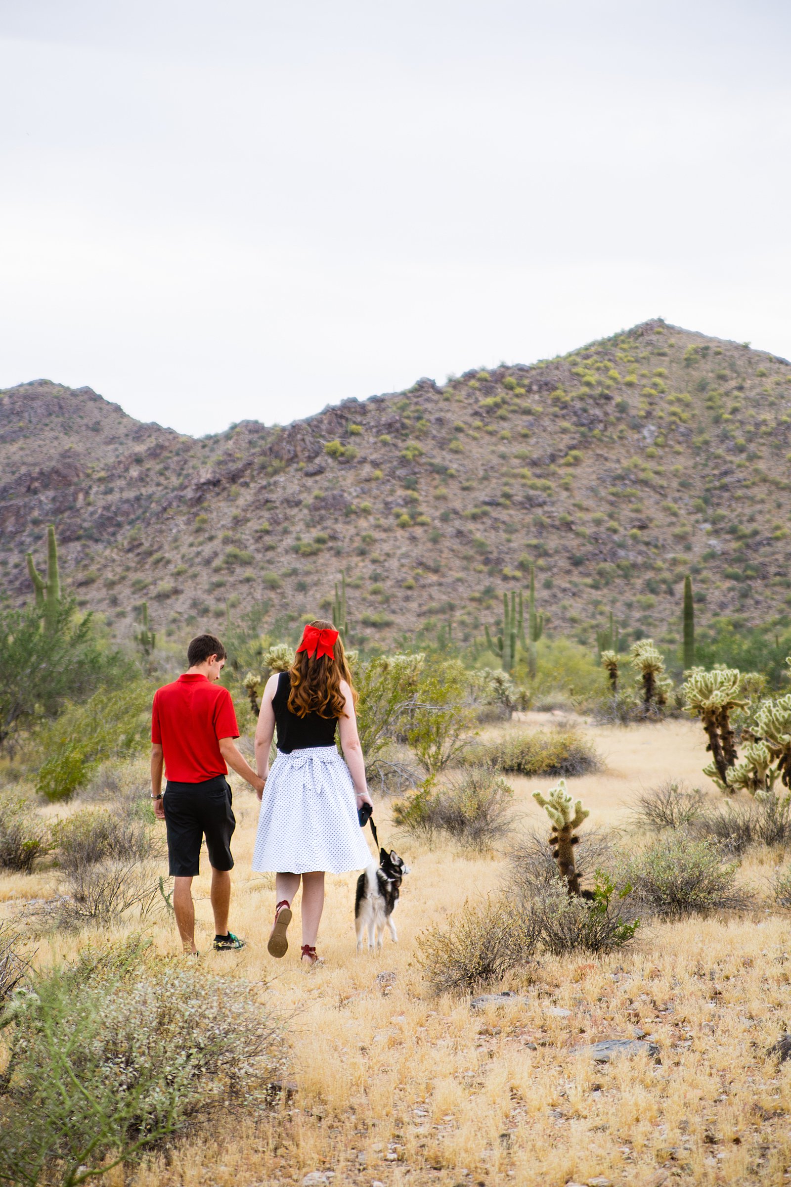 Couple walking together during their Phoenix anniversary session by Arizona engagement photographer PMA Photography.